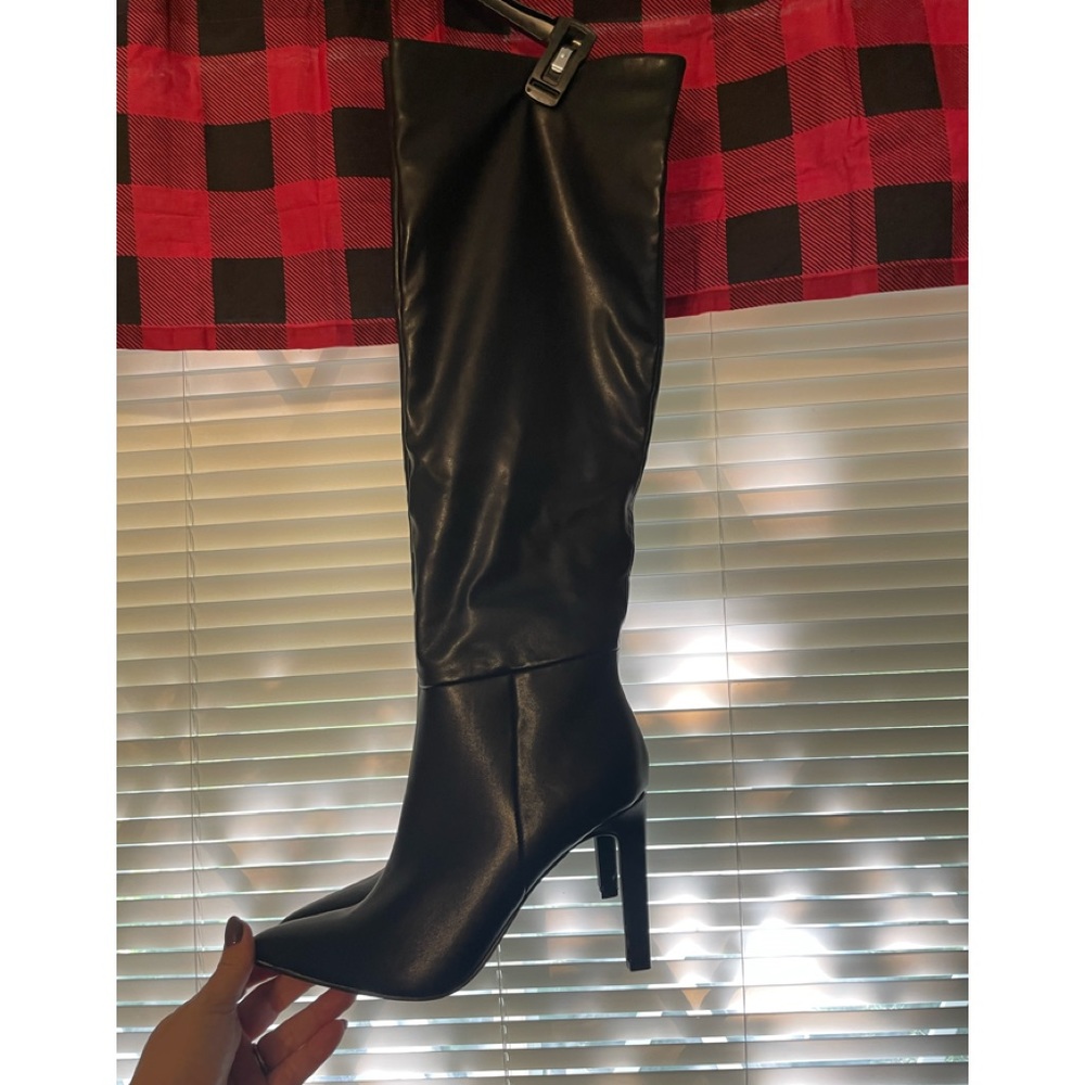 Knee high  black faux leather boot.